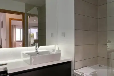 a bathroom with a sink and a shower at Tamariz Sea View, a Home in Madeira in Caniço