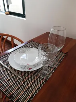 a wooden table with a plate and glasses on it at FXapartment1 in Funchal