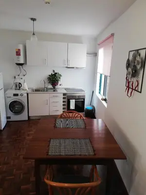 a kitchen with a wooden table in a room at FXapartment1 in Funchal