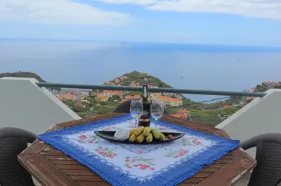 a white building with a balcony on top of it at Fifty`s House 1 By Sam Houses in Ribeira Brava