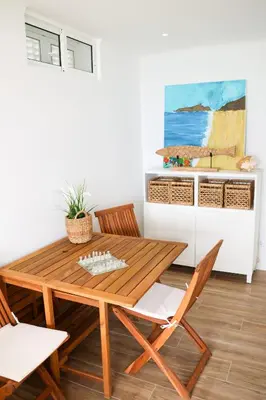 a dining room with a wooden table and chairs at Seashore Villa - Porto Santo in Porto Santo