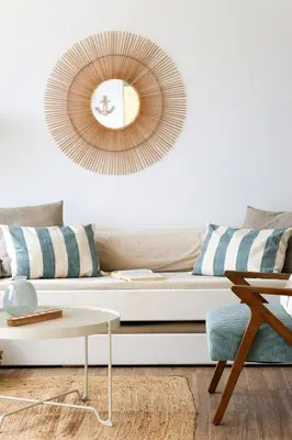 a living room with a couch and a mirror at Seashore Villa - Porto Santo in Porto Santo
