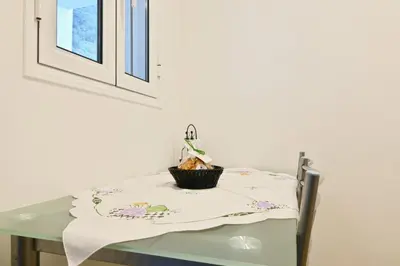 a table with a table cloth and a plant on it at Casa Familia Pestana 1, a Home in Madeira in Seixal