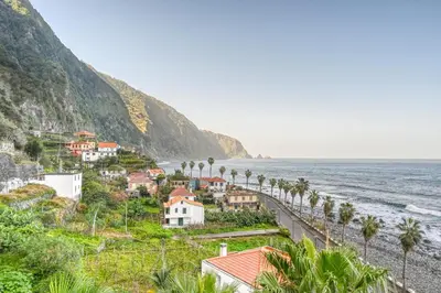 a town on a hill next to the ocean at Casa Familia Pestana 1, a Home in Madeira in Seixal