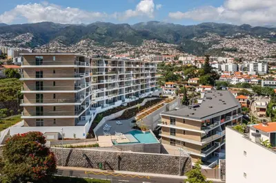an apartment building with a garden on the side at Koala Bay Place in Funchal
