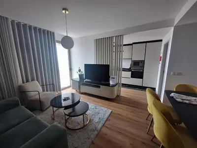 a living room with a couch and a tv at Koala Bay Place in Funchal