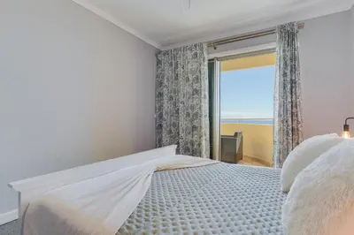 a bedroom with a bed with a view of the ocean at Apartament Falesia Paradise by Holiday Rental Madeira in Funchal