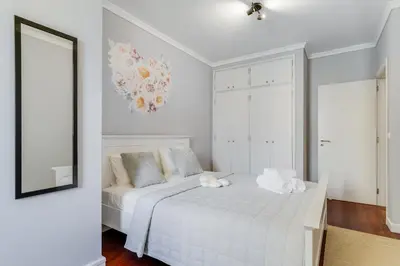 a bedroom with a white bed with towels on it at Apartament Falesia Paradise by Holiday Rental Madeira in Funchal