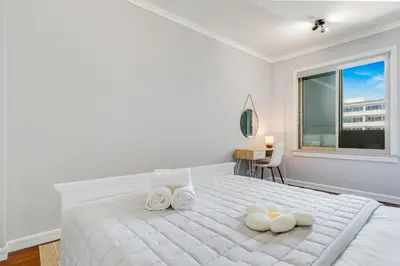 a white bedroom with a bed with two white towels at Apartament Falesia Paradise by Holiday Rental Madeira in Funchal