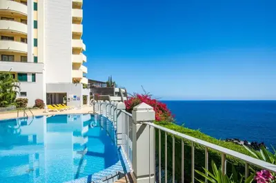 a swimming pool with the ocean in the background at Apartament Falesia Paradise by Holiday Rental Madeira in Funchal