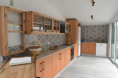 a kitchen with wooden cabinets and a counter top at Vale dos Ilhéus in Machico