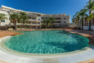 a large swimming pool in front of a building at Vilamos in Lagos by Algarve Golden Properties in Lagos