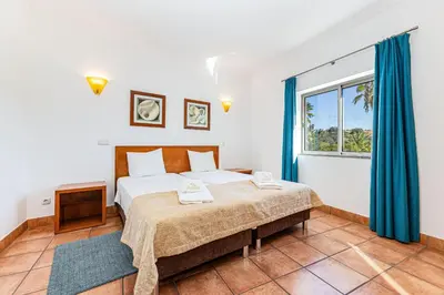 a bedroom with a bed and a window at Vilamos in Lagos by Algarve Golden Properties in Lagos