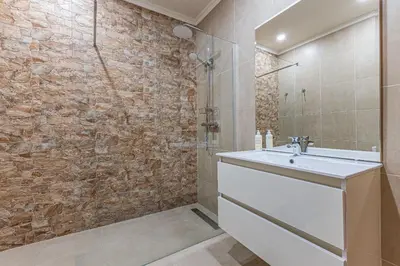 a bathroom with a sink and a shower at Vilamos in Lagos by Algarve Golden Properties in Lagos