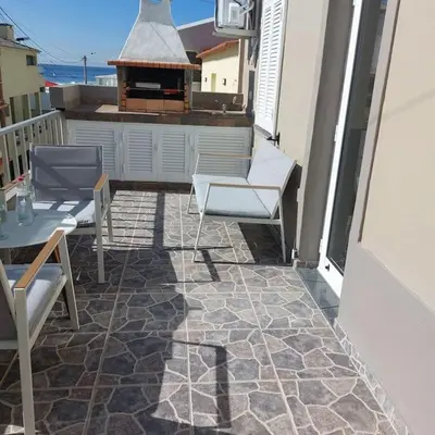 a patio with chairs and a grill on a balcony at Casa Tropicana in Paul do Mar
