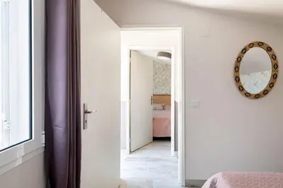 a hallway with a mirror and a room with a bed at Casa Tropicana in Paul do Mar
