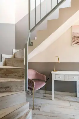 a staircase with a chair and a desk in a room at Casa Tropicana in Paul do Mar
