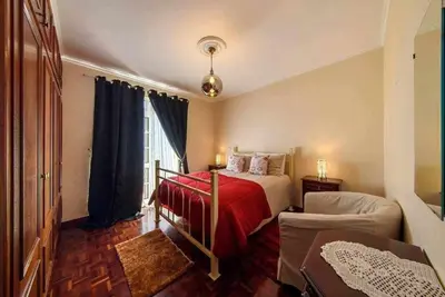 a bedroom with a bed with a red blanket at Casa do Tornadouro by Mth in Ponta do Sol