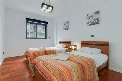 a bedroom with two beds and a window at Ramos Apartment by Holiday Rental Madeira in Funchal