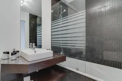 a bathroom with a white sink and a shower at Ramos Apartment by Holiday Rental Madeira in Funchal