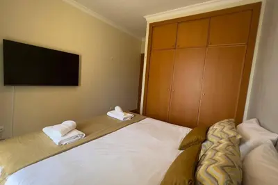 a bedroom with a bed with two towels on it at By the Sea V - Panoramic Pool Retreat in Funchal