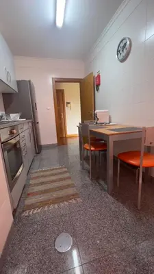 a kitchen with a table and chairs and a dining room at By the Sea V - Panoramic Pool Retreat in Funchal