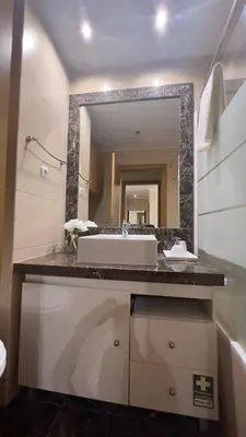 a bathroom with a sink and a mirror at By the Sea V - Panoramic Pool Retreat in Funchal