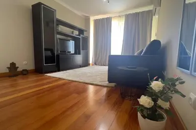 a living room with a couch and a television at By the Sea V - Panoramic Pool Retreat in Funchal