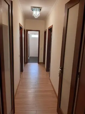 a corridor of a hallway with doors and a chandelier at Residência do Saramago in São Vicente