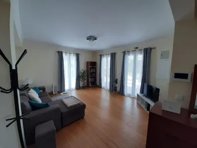 a living room with a couch and a television at Residência do Saramago in São Vicente