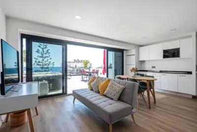a living room with a couch and a table at Over Sea in Funchal