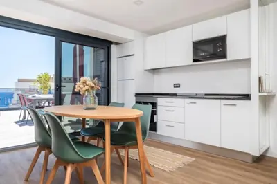 a kitchen and dining room with a table and chairs at Over Sea in Funchal