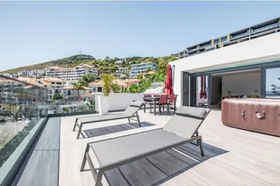 a balcony with chairs and a view of the city at Over Sea in Funchal