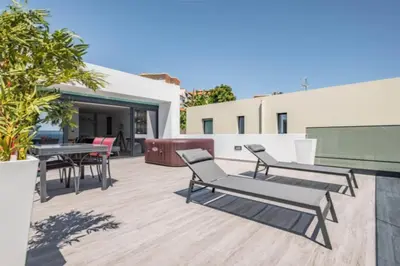 a patio with chairs and tables on a building at Over Sea in Funchal