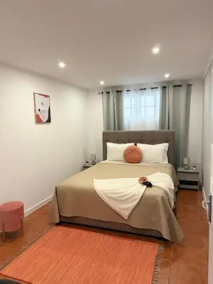 a bedroom with a large bed and a window at Gouveia Family Escape in Machico