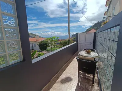 a balcony with a table and a view of the ocean at Gouveia Family Escape in Machico
