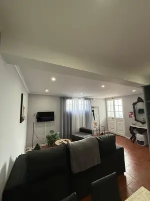 a living room with a couch and a tv at Gouveia Family Escape in Machico
