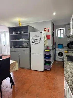 a kitchen with a refrigerator with a sign on it at Gouveia Family Escape in Machico
