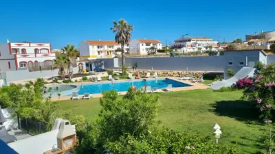 a view of a swimming pool in a resort at ENJOY POOL, BEACH and more at this nice 2bedroom apartment only 3 minutes from Mareta's Beach in Sagres