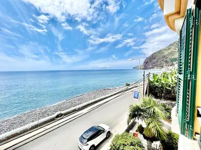 a car parked on a road next to the ocean at Apartment Paulo by Your Madeira Rentals in Ponta do Sol