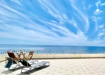 a patio with a table and chairs and the ocean at Apartment Paulo by Your Madeira Rentals in Ponta do Sol
