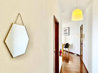 a mirror hanging on a wall in a hallway at Apartment Paulo by Your Madeira Rentals in Ponta do Sol
