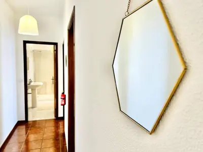 a mirror hanging on a wall next to a bathroom at Apartment Paulo by Your Madeira Rentals in Ponta do Sol