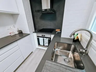 a kitchen with a sink and a stove at Casa da Ponta Negra in Vila do Porto