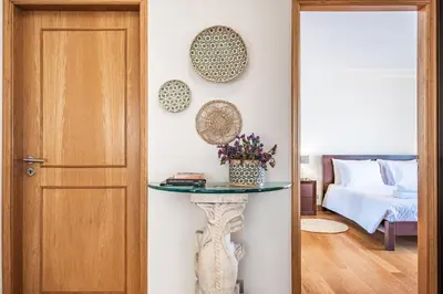 a room with a table next to a door at Casa da Palmeira in Funchal