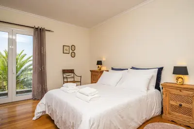 a bedroom with a bed with towels on it at Casa da Palmeira in Funchal