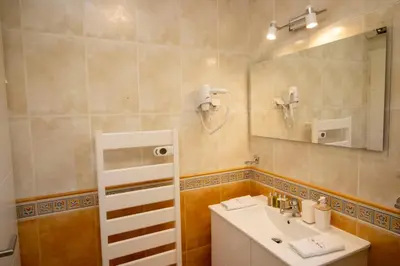 a bathroom with a sink and a mirror at Villa Ílios - Porto de Mós, Lagos in Lagos