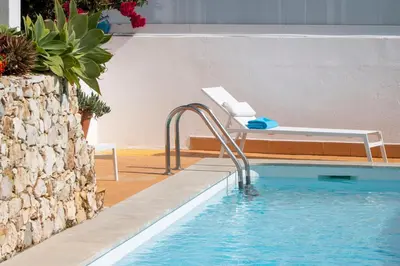a swimming pool with a pool noodle in a house at Villa Ílios - Porto de Mós, Lagos in Lagos