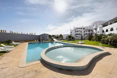 a large swimming pool in front of a building at Victoria's House in Sagres