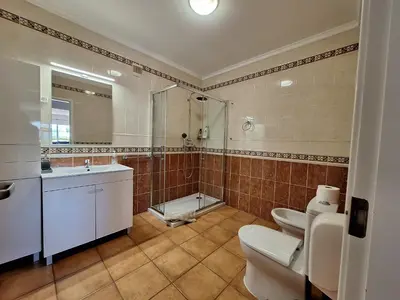a bathroom with a toilet and a sink and a shower at Amazing Studio with Ocean View in Lagos